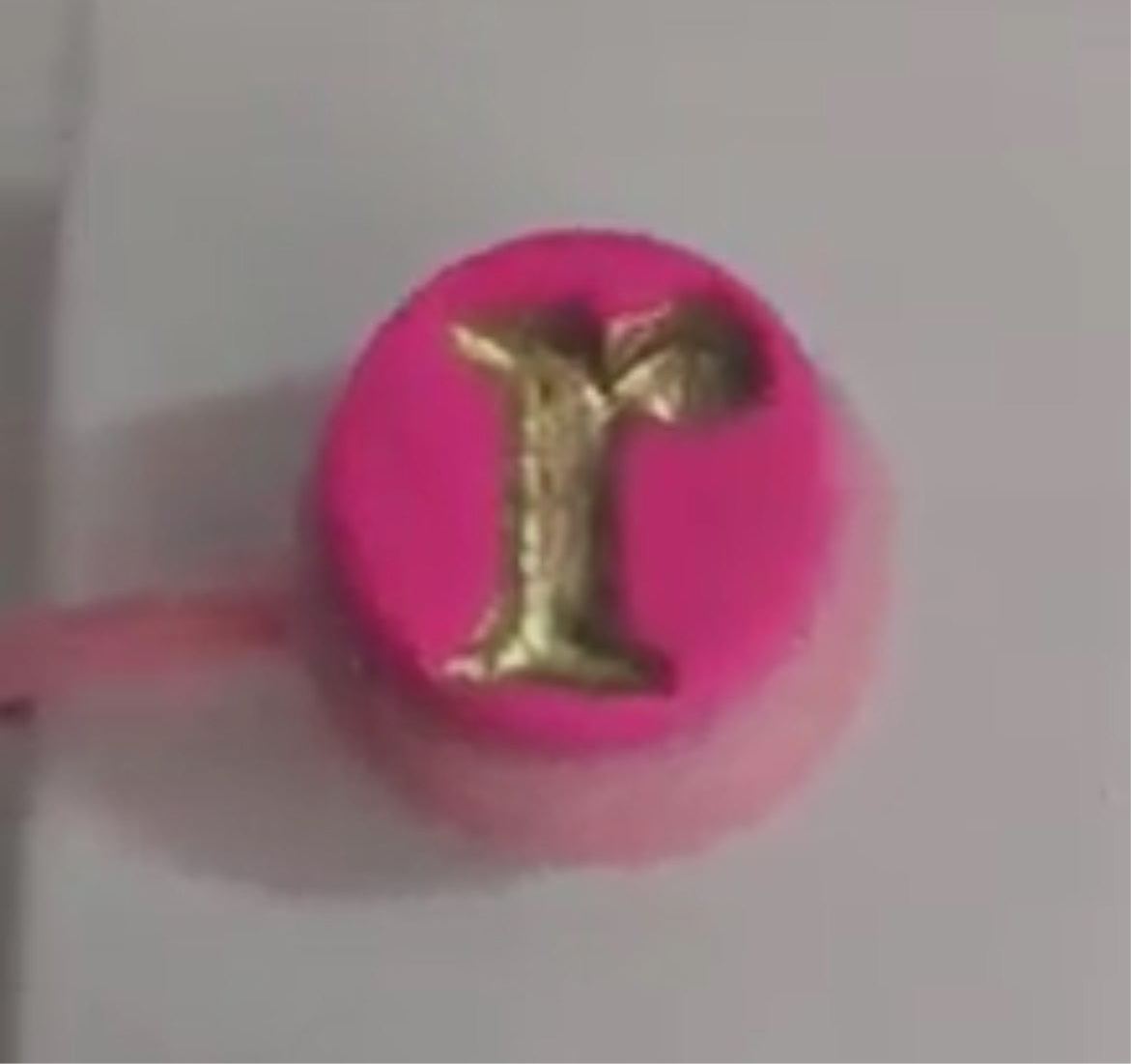 Straw Cover Caps with a vibrant pink design and a golden letter 'r' on top, perfect for protecting drinks.