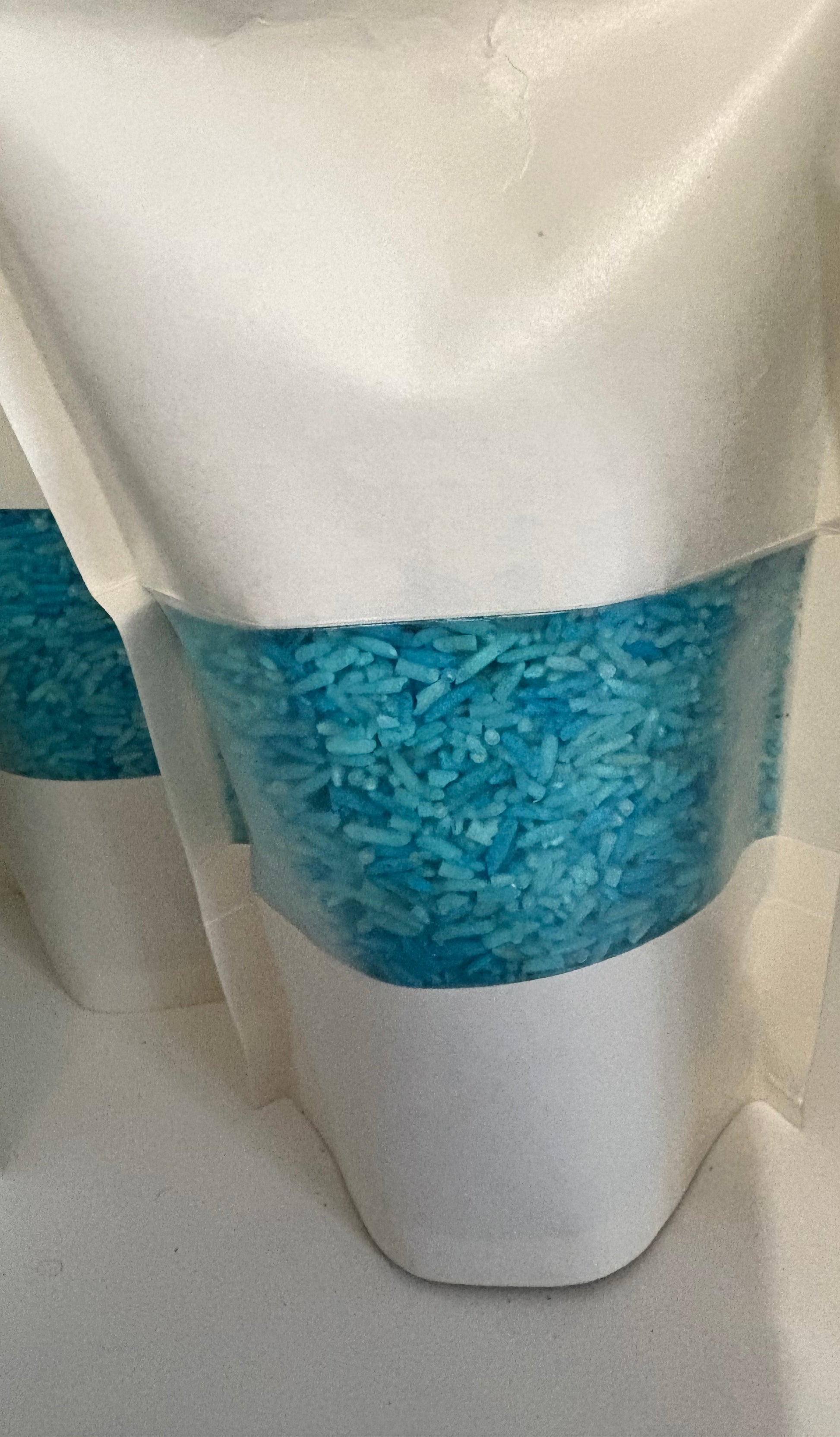 A bag of Krafty Kat Sensory Rice coloured blue