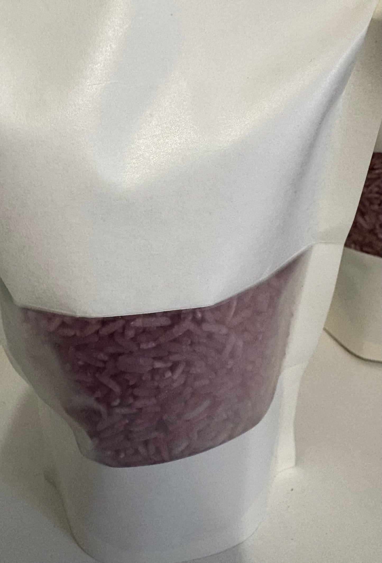 A bag of Krafty Kat Sensory Rice coloured purple