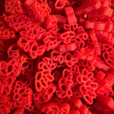 Some of Krafty Kat's Sensory Pasta being coloured red dinosaurs