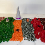 Sensory Mix showing allergen-free coloured chickpeas, rice, white beans & pastas with mini Halloween figurines on top.