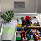 Krafty Kat traffic sensory play kit with toys and kinetic sand in a clear container.