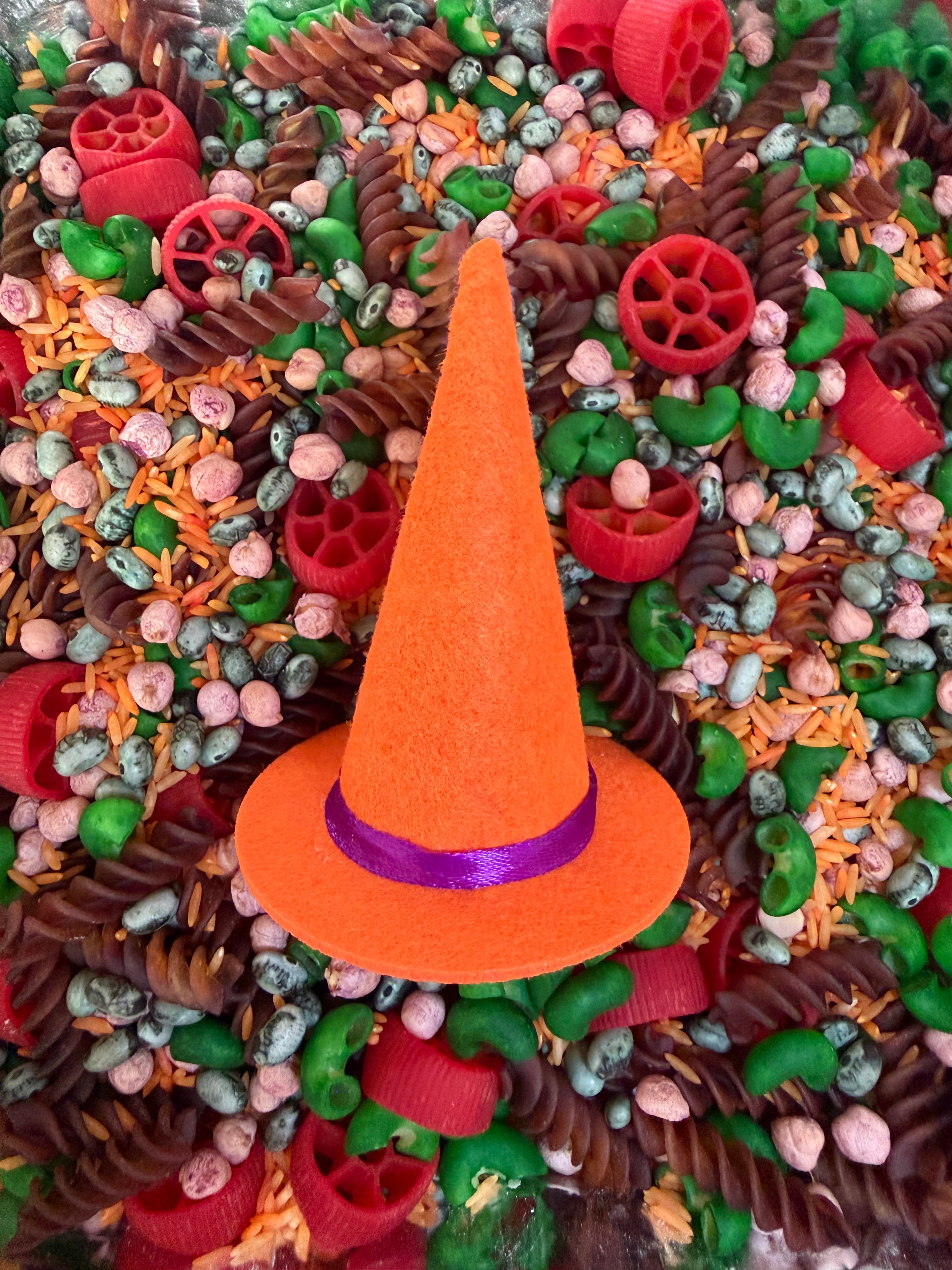 The Halloween Sensory Mix with a bright orange mini witches hat in the middle on top
