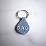 Light Blue Imprinted White ‘Dad’ Leather-Look Silver Keyrings - Krafty Kat